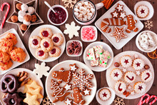 Christmas Table Scene Of Assorted Sweets And Cookies. Top View Over A Rustic Wood Background. Holiday Baking Concept.
