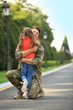 © New Africa - Father in military uniform hugging his little daughter at sunny park