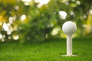 Wall Mural - Golf ball on tee at green course