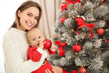 Sticker - Happy mother with cute baby near Christmas tree at home