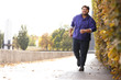 © New Africa - Young overweight man running in park. Fitness lifestyle
