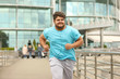 © New Africa - Young overweight man running outdoors. Fitness lifestyle