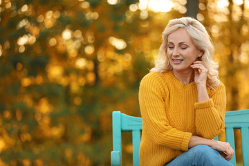 Wall Mural - Portrait of happy mature woman in park