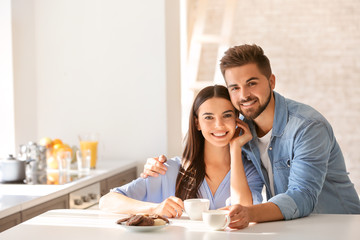 Wall Mural - Happy young couple in kitchen at home