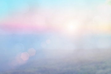 Natural background blurring warm colors and bright sun light. Bokeh or Christmas background Green Energy at sky sunny color orange light patterns plain abstract flare evening clouds blur.