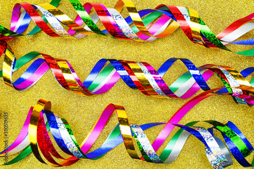 Christmas glittery streamers on a gold background