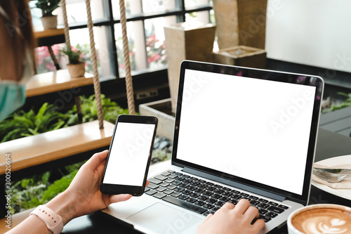 Fotografía mockup image computer,cell phone blank screen for hand typing text,using laptop contact business searching information in workplace on desk at office