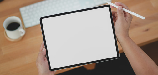 Canvas Print - cropped shot of young man holding blank screen tablet