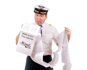 The pilot looks into instructions about using the aircraft, isolated on white background. Aircraft captain is studying a manual about flying.