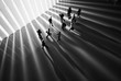 © AHMAD FAIZAL YAHYA - Miniature toys studio set up - Top view of black and white effect of people with long shadows busy walking during sunrise or sunset. Noise added for dramatic effect.