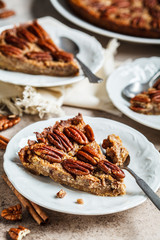 Wall Mural - Piece of pecan Pie on gray-brown background. Vegan dessert concept.