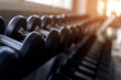 © inews77 - Blurred background of Rows of black dumbbells on rack in the gym, Weight training equipment in sport fitness center..
