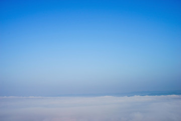blue sky with clouds and fog background