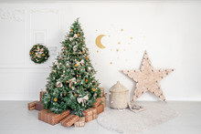 Childrens Room With Decorated Christmas Tree And Presents. Christmas Morning. White Room With Stucco.