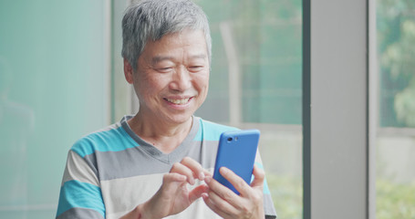 old man use smart phone
