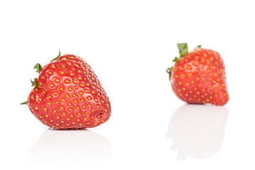 Group of two whole fresh red strawberry isolated on white background