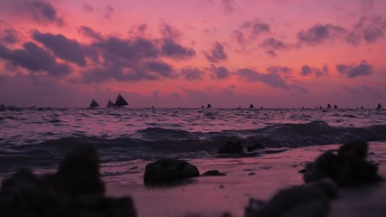 Wall Mural - Amazing colors of tropical sunset. Sail boats silhouettes floating on ocean horizon. Boracay island, Philippines summer vacation