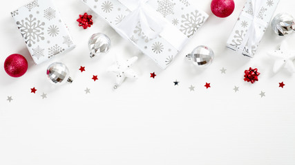 christmas frame top border made of gifts, balls, stars, confetti. red and silver colors. flat lay, t
