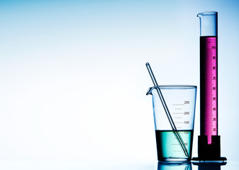 Wall Mural - different laboratory glassware with color liquid and with reflection