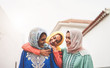 © Alessandro Biascioli - Happy Muslim girlfriends having fun walking outdoor - Arabian girls sharing time and conversation together in the college - People religion culture and friendship concept