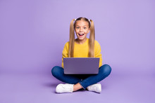 Full Size Photo Of Amazed Child Sit Folded Crossed Legs Work Computer Get Social Media Notification Scream Wow Omg Wear Yellow Pullover Sneakers Isolated Over Purple Color Background