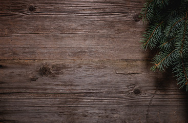 Wall Mural - Christmas green frame from fir branches on a vintage gray board background. Frame of fir branches. Christmas card blank.