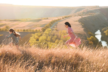 Sticker - happy mother and daughter running in field