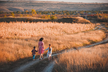 Poster - mother walking with children in fields