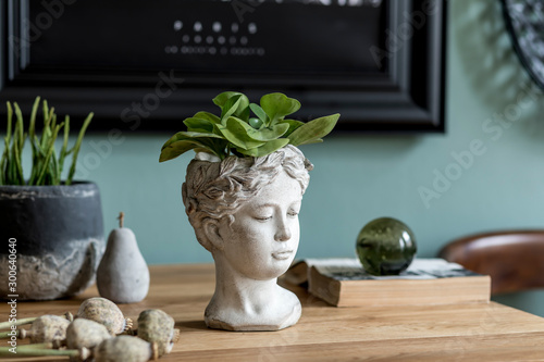 Fotografía Stylish composition of interior design with modern cement sculpture pot, plants, book and elegant decoration on the wooden table
