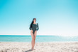 © Haibullaev - Girl with black hair is walking along the beach in a bodysuit