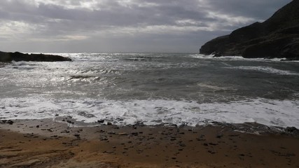 Sticker - Spanish beach sea waves at cloudy rainy weather. Cala Reona in Cabo de Palos. Mediterranean Sea landscape, coast in Murcia region. Tourist site. Slow motion