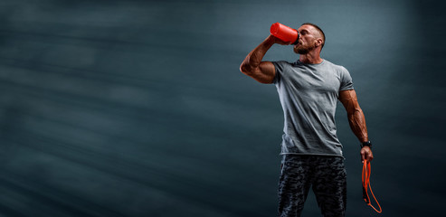 nutritional supplement. muscular men drinks protein, energy drink after workout