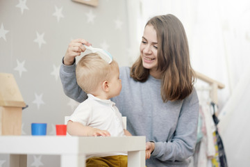 mom combing baby hair