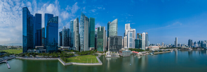 High rise office towers of the Singapore central business and financial district aerial panorama on a sunny morning including waterfront and reflection