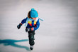 young boy skating on ice in winter, kids seasonal sport