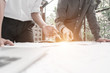 © I Believe I Can Fly - engineers pointing to building on blueprint to drawing design building project outside the office, construction concept. Engineer concept