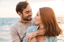 Photo Of Joyful Romantic Couple Smiling At Each Other And Hugging