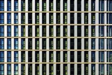 Sticker - Modern building with glass windows silently witnessing the life of the big city