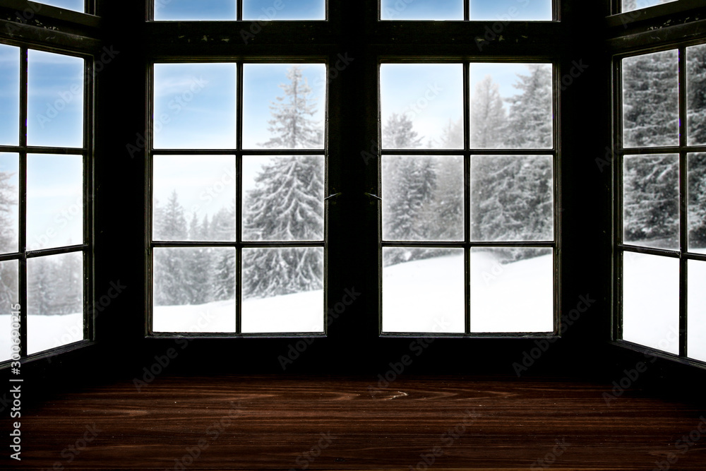 Table top with big window background and beautiful snowy winter landscape outside. Sunny winter day.