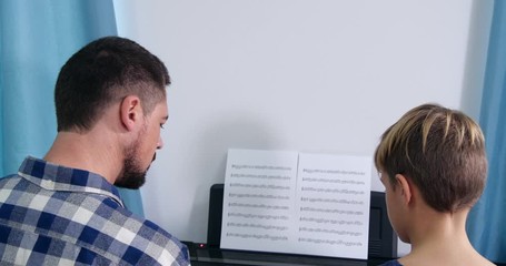 Poster - Man teaching boy to play piano in room