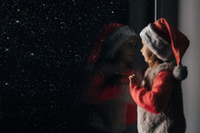  Child Looks Out The Window On Christmas Of Jesus Christ.