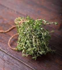 Wall Mural - Bunch of garden thyme herb on wooden table