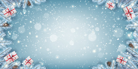 Wall Mural - creative frame made of christmas snowy fir branches, gift boxes, snowflakes, light, stars on blue ba