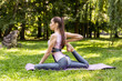 © IVASHstudio - Athletic girl is doing advanced yoga asana on the fitness mat outdoors