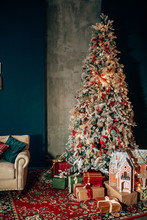 Brightly Christmas Tree In A Room With Red Carpet With Lots Of Gifts Under It. New Year Holidays.