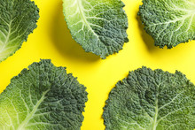 Fresh Savoy Cabbage Leaves On Yellow Background, Flat Lay