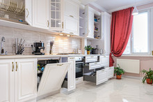 Luxury Modern White Kitchen Interior With Open Doors And Drawers