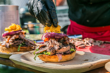 Close up hands of chef preparing fresh burger . Cooking concept