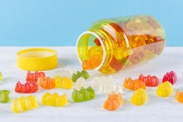 vitamins for children like jelly candy on the table and blue background