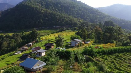 Wall Mural - Aerial view morning scene of Pa Bong Piang paddy terraced rice fields with farm huts, Mae Chaem, Chiang Mai Thailand